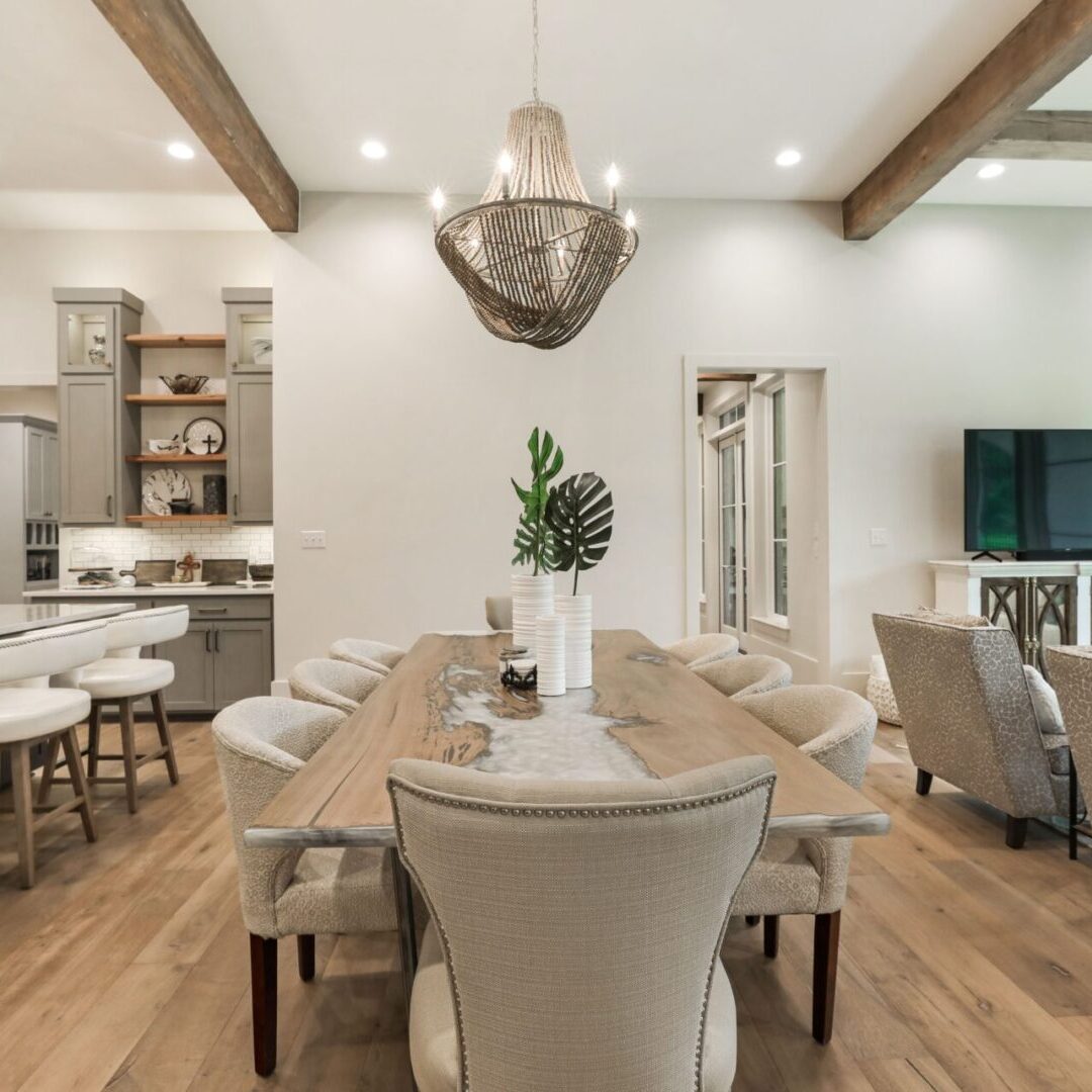 A dining room with a large table and chairs.