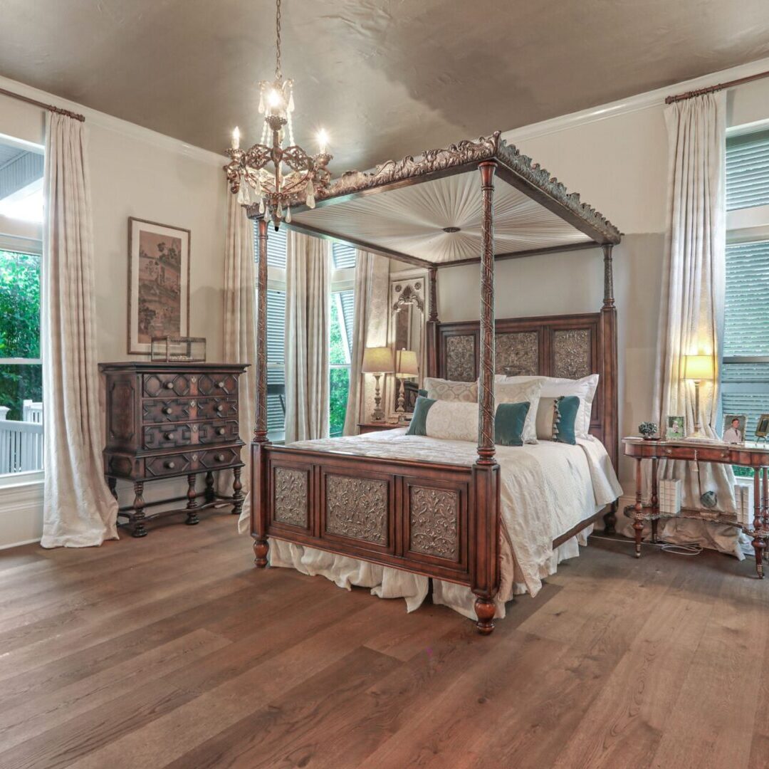 A bedroom with a bed, dresser and window.