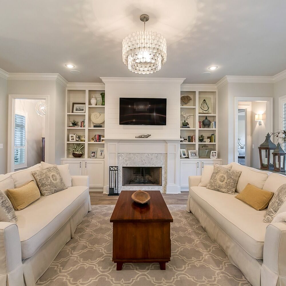 A living room with two couches and a fireplace.